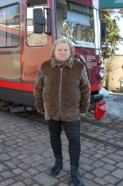 Carsten Wasow mit Leojacke vor einem Zug der Rittenerbahn (Februar 2019)